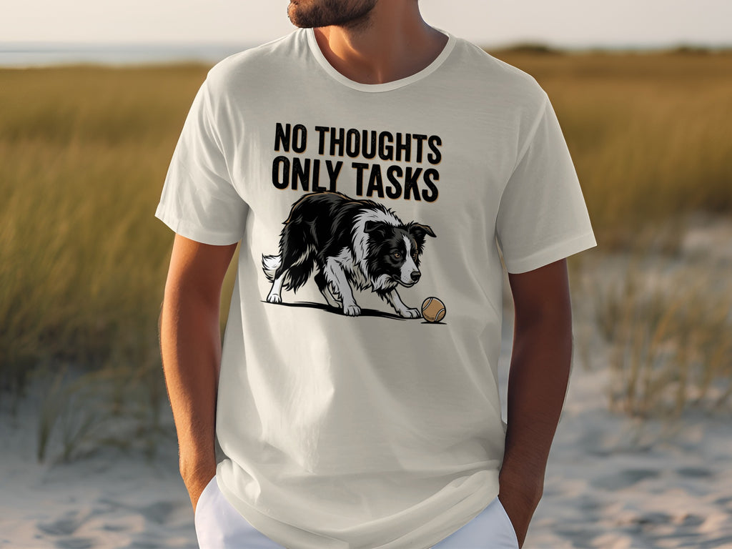White t-shirt with black dog and ball, text "NO THOUGHTS ONLY TASKS".