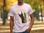 Man wearing a pink t-shirt with a Doberman peeking through an open door.