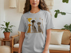 Grey t-shirt featuring a minimalist graphic of three dogs sitting together.