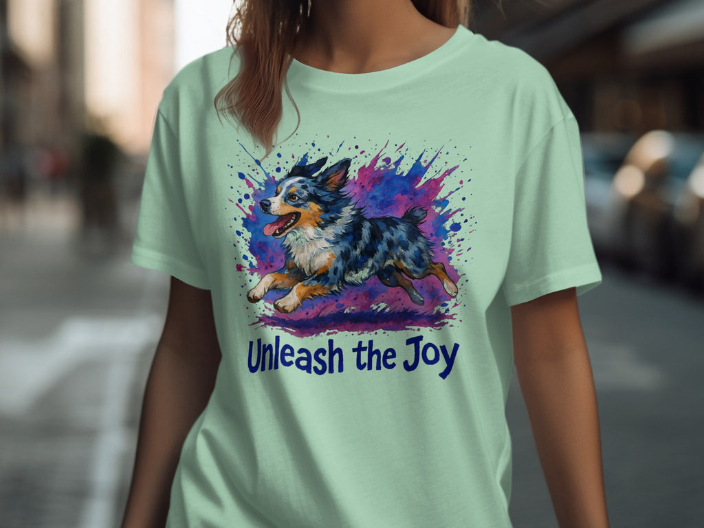 Light green t-shirt with watercolor dog art and "Unleash the Joy" text.
