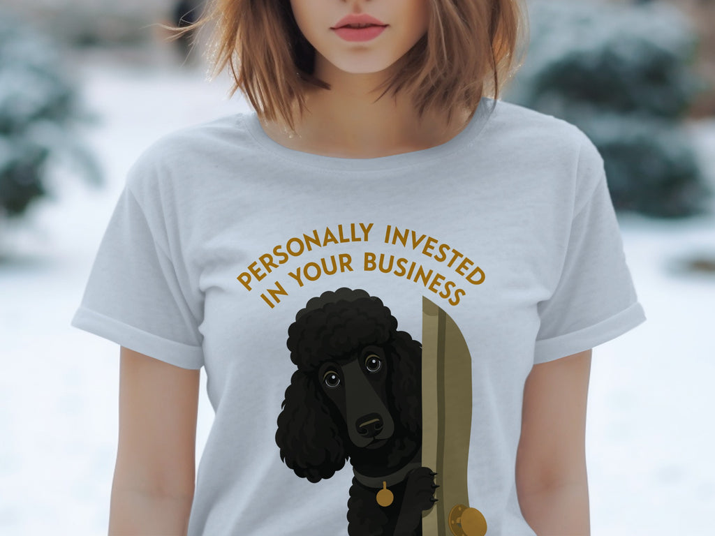 Light grey t-shirt with a black poodle peeking through a doorway.