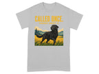 Black Labrador dog in a grassy field with yellow text.