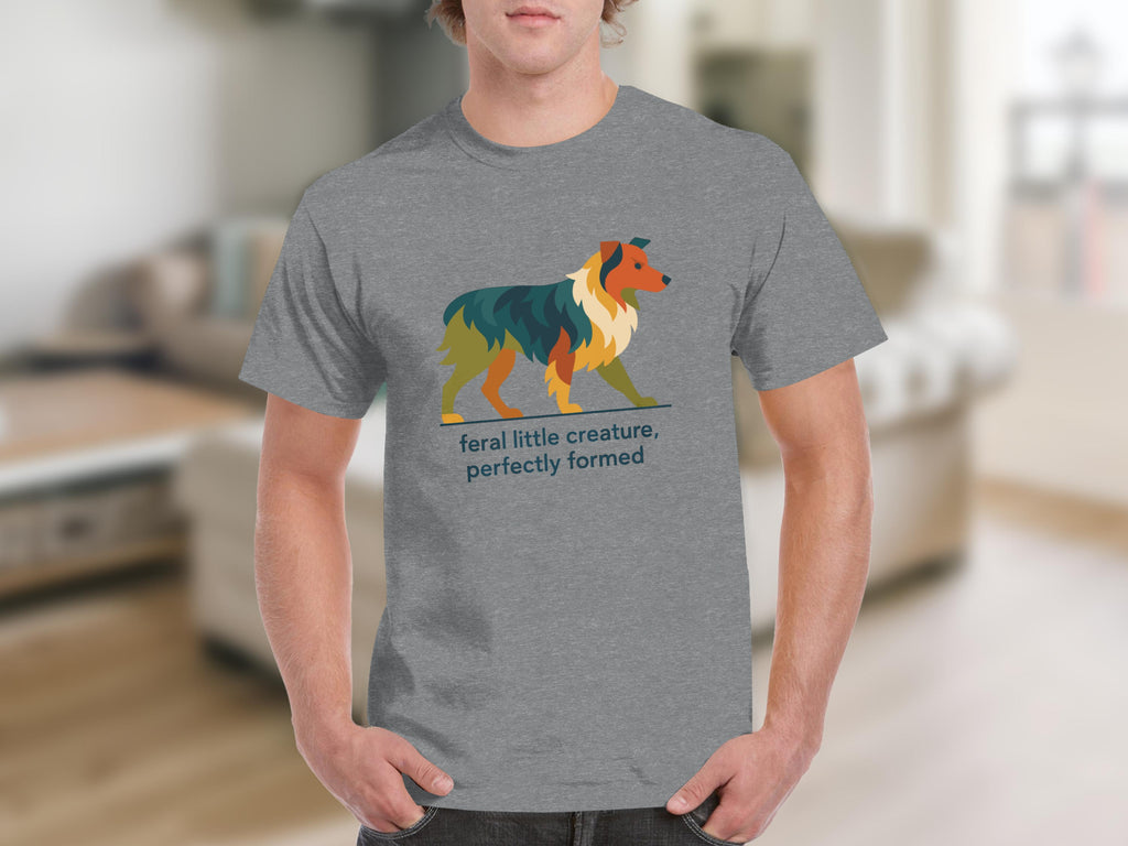 Grey t-shirt with geometric dog art and text "feral little creature, perfectly formed".