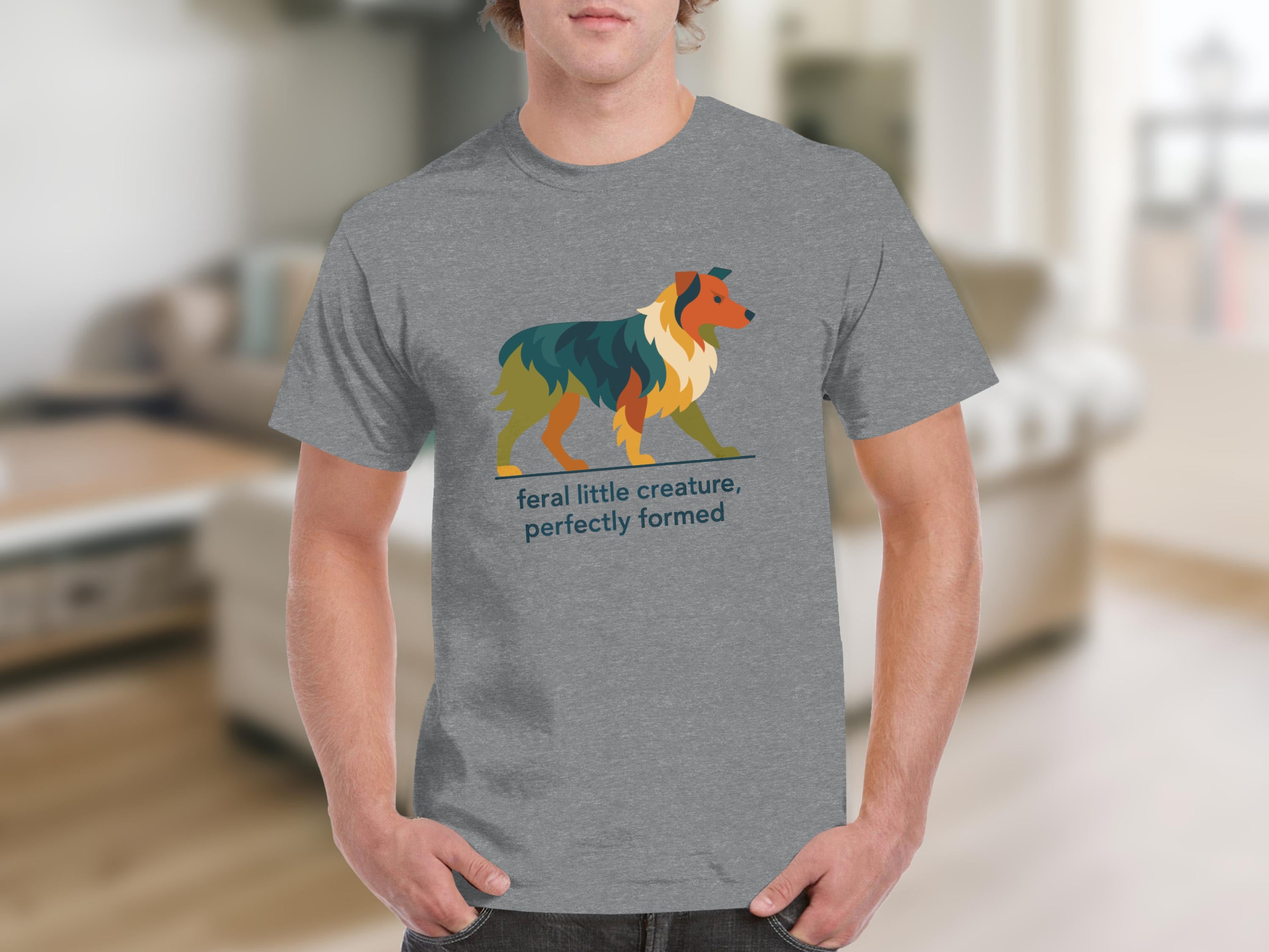 Grey t-shirt with geometric dog art and text "feral little creature, perfectly formed".