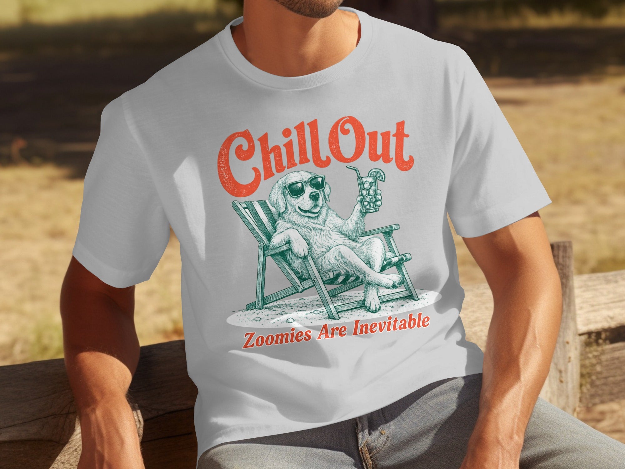 Man in white t-shirt with graphic of dog in sunglasses relaxing with drink.