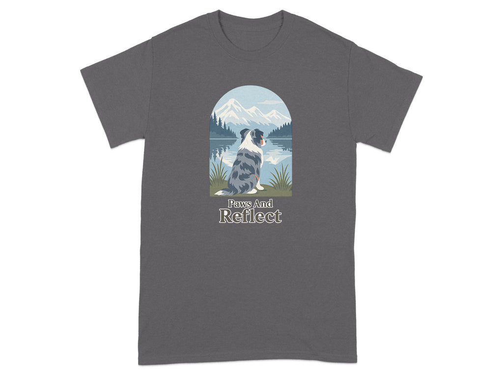 Dog sitting by a lake with mountains, text "Paws And Reflect".