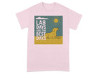 Pink t-shirt with graphic: yellow lab, sun, clouds, "LAB DAYS ARE THE BEST DAYS" text.
