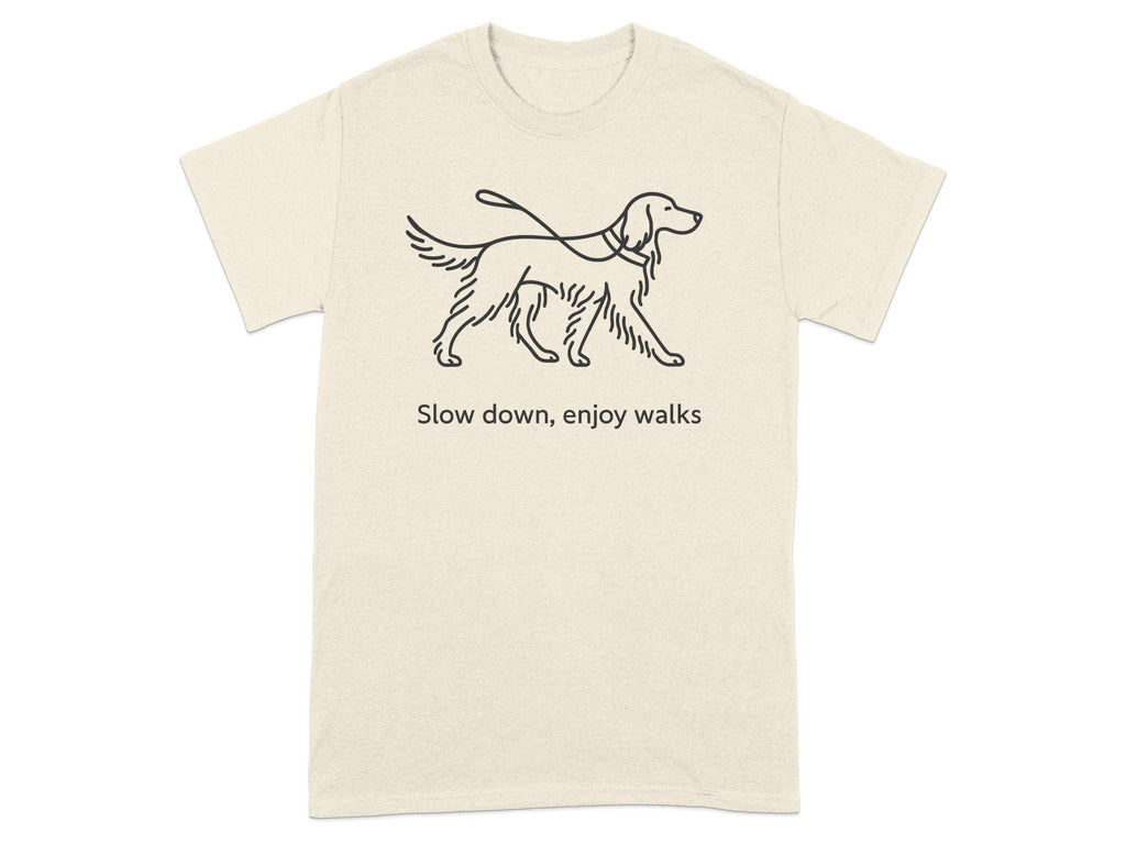Cream t-shirt with linework drawing of a dog on a leash and text "Slow down, enjoy walks".