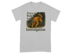 Grey t-shirt with a golden retriever wearing a hat, below text "Every Walk Is an Investigation".