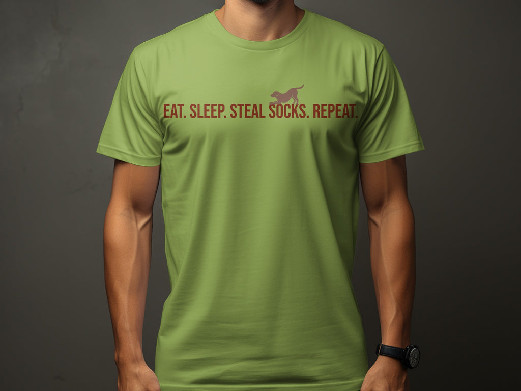 Green t-shirt with text "Eat. Sleep. Steal. Socks. Repeat." and a dog silhouette.