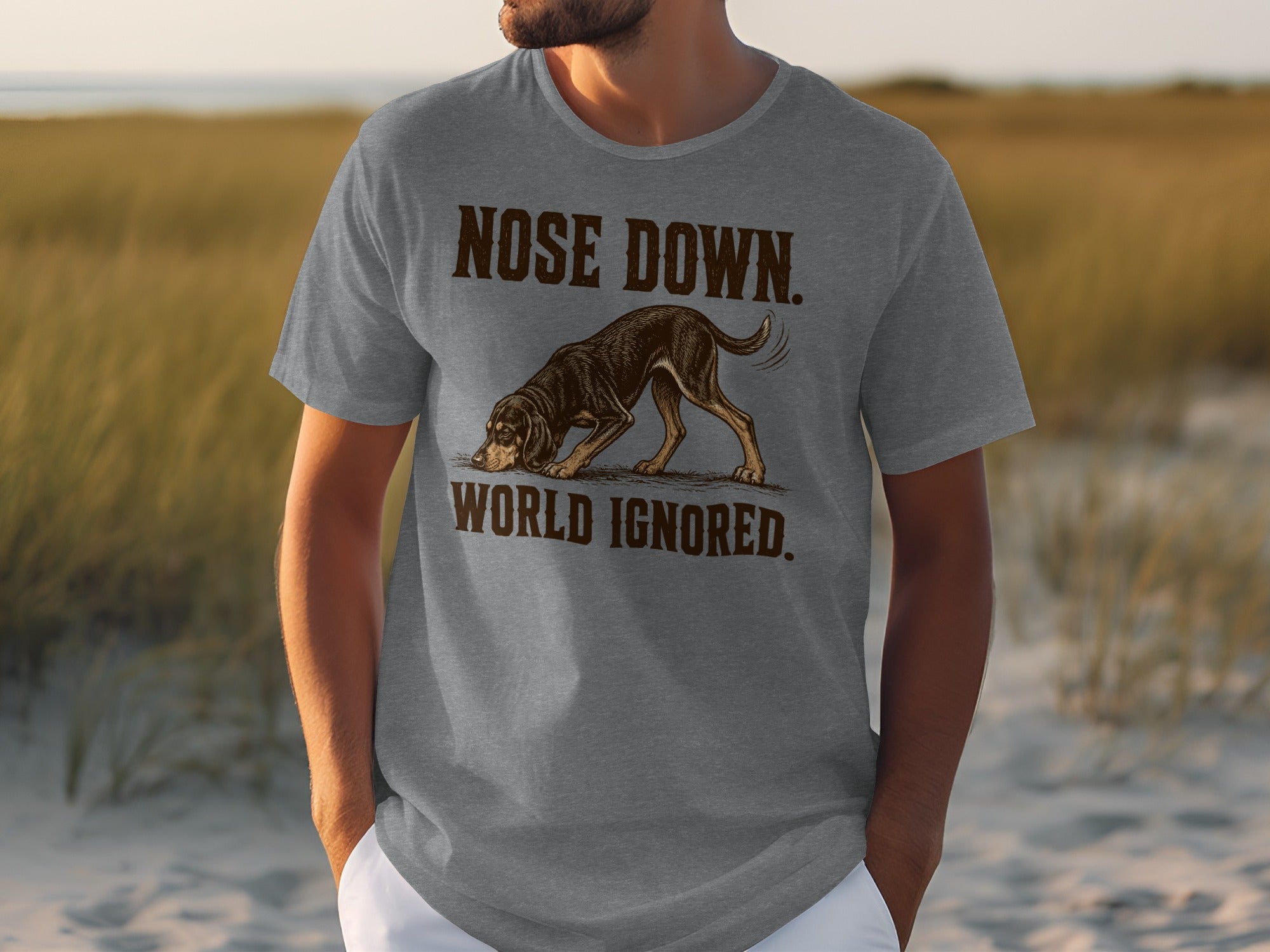 Grey t-shirt with graphic of a dog with "Nose Down, World Ignored" text.