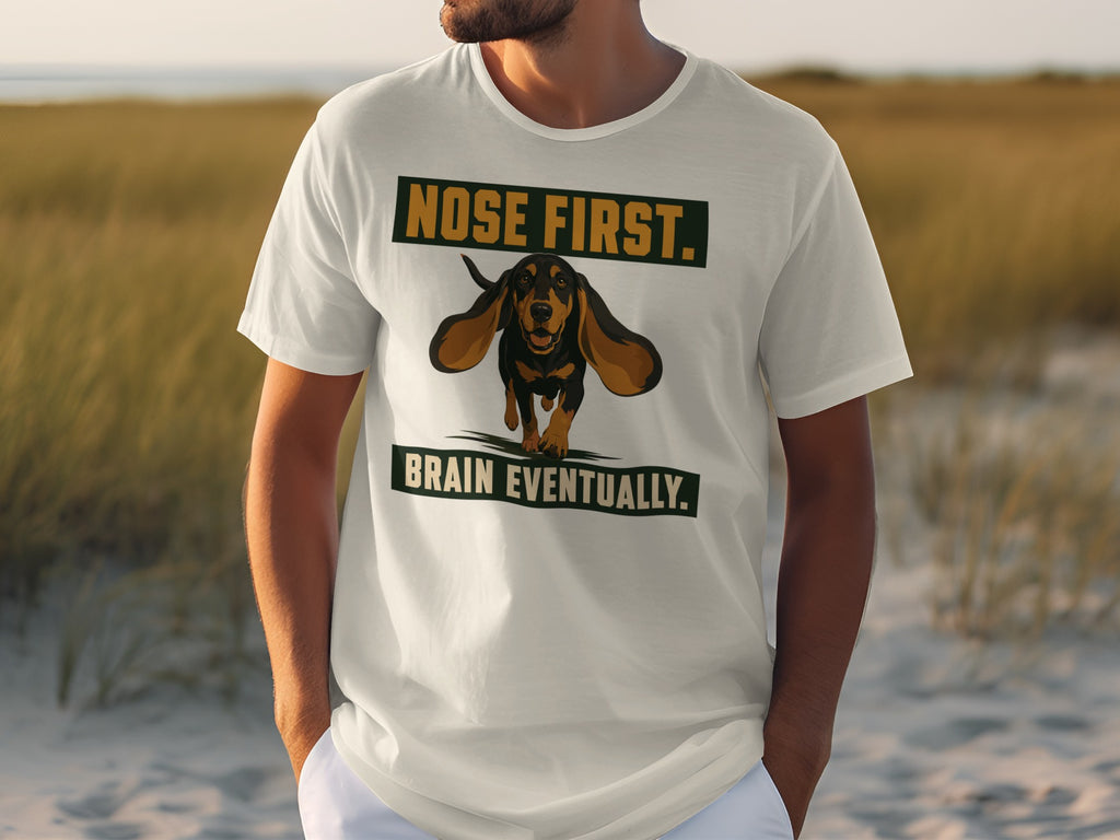 White t-shirt with "NOSE FIRST. BRAIN EVENTUALLY." and a dachshund graphic.