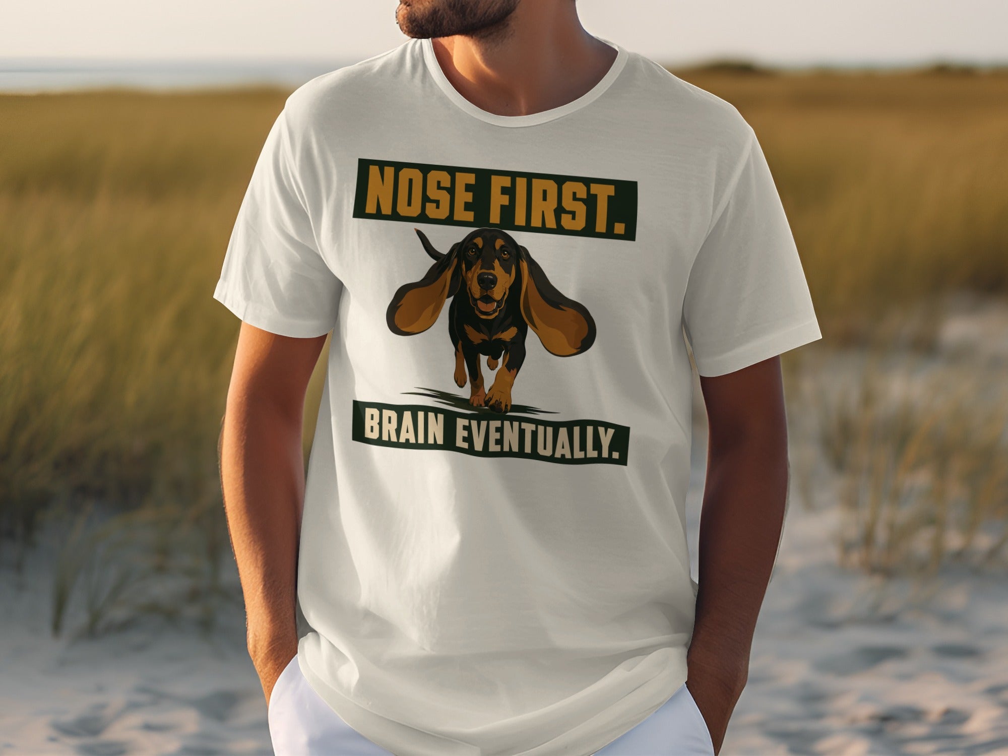 White t-shirt with "NOSE FIRST. BRAIN EVENTUALLY." and a dachshund graphic.