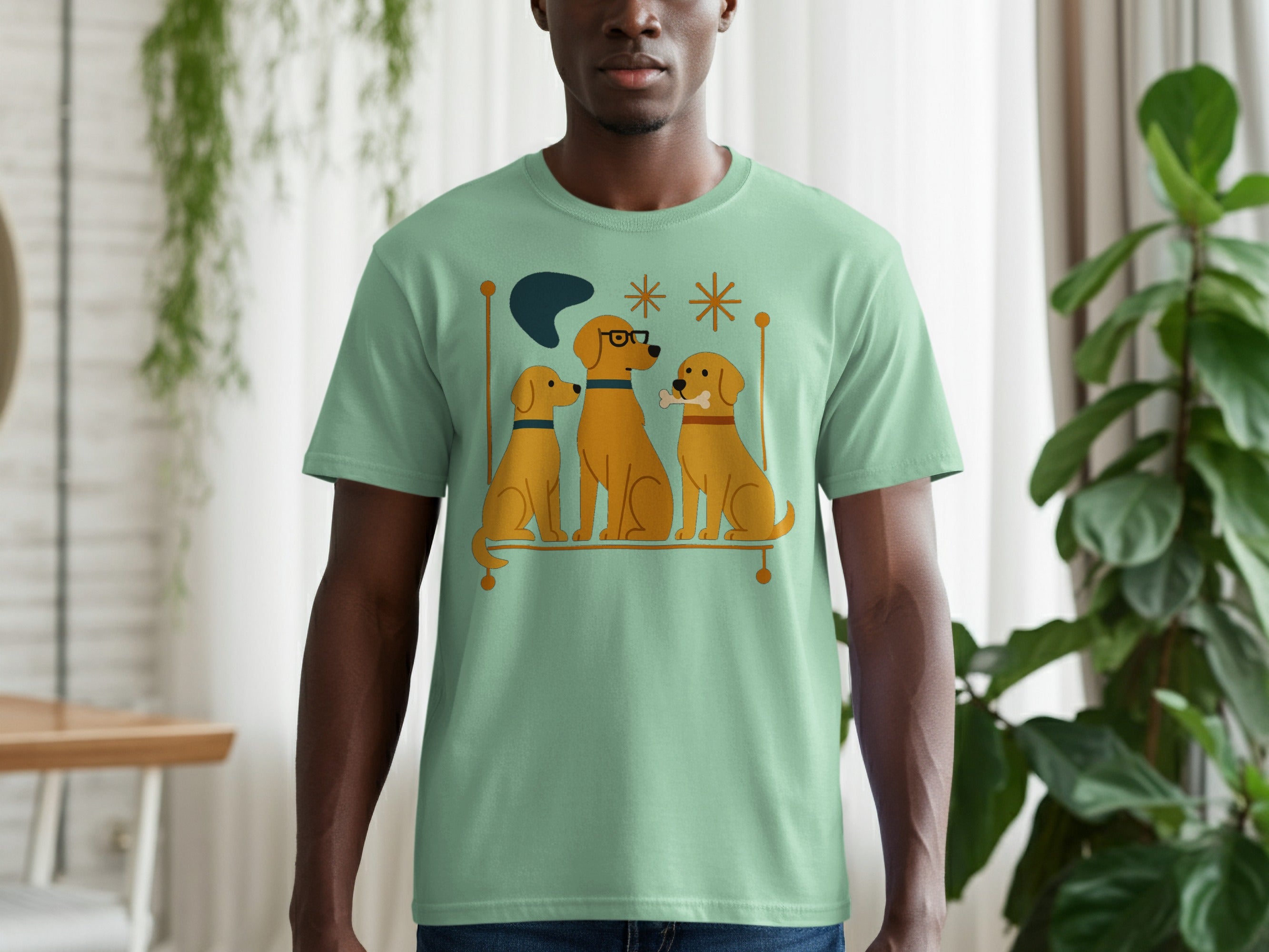 Light green t-shirt with a graphic of three golden dogs with decorative elements.