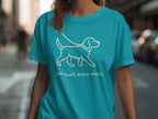 Teal t-shirt with white line drawing of a dog and text "Slow down, enjoy walks".