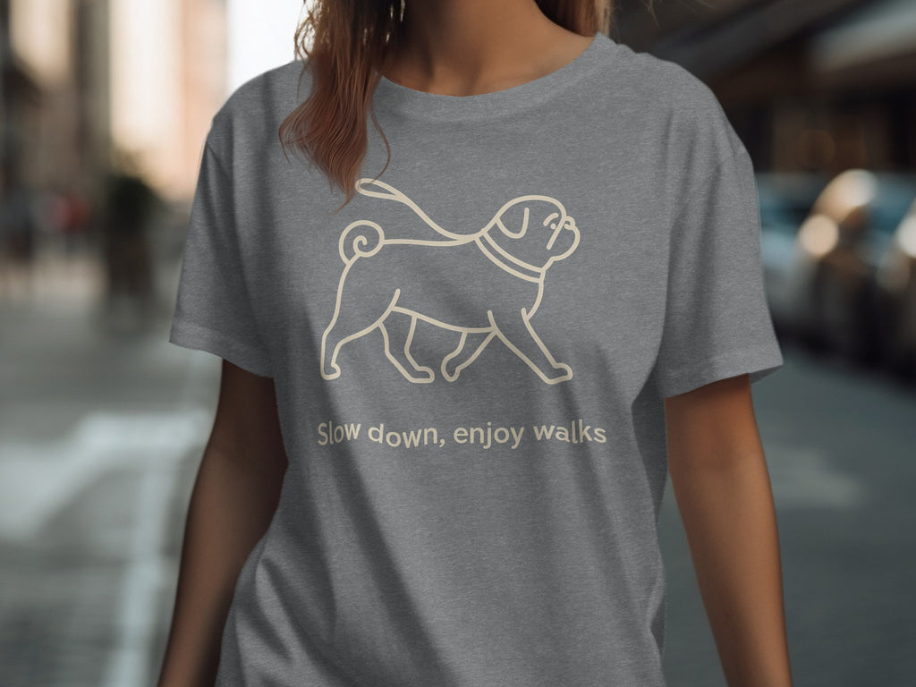 Grey t-shirt with a line drawing of a pug on a leash and the text "Slow down, enjoy walks".