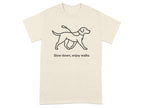 Cream t-shirt with black line drawing of a dog on a leash and text "Slow down, enjoy walks".
