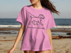 Pink t-shirt with black line art of a dog and text "Slow down, enjoy walks".