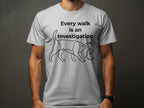 White t-shirt with a dog wearing a detective hat and the text "Every walk is an Investigation."