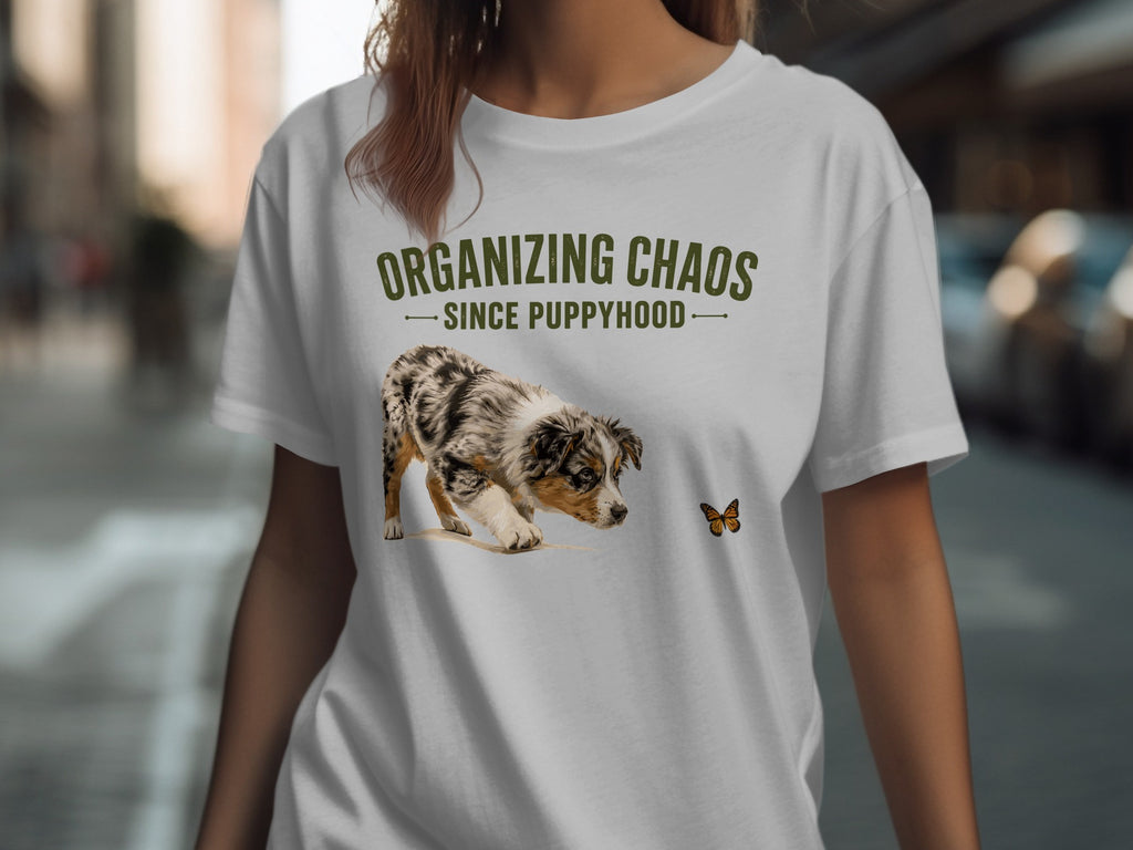 White t-shirt with "Organizing Chaos Since Puppyhood" and a puppy sniffing a butterfly.