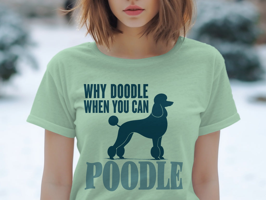 Light green t-shirt with a dark blue poodle silhouette and text "WHY DOODLE WHEN YOU CAN POODLE".