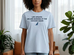 Light blue t-shirt with "LIFE UPDATE: WE ARE BARKING AT THE VACUUM AGAIN" and dog graphic.