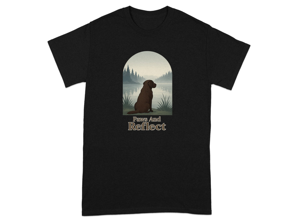 Black t-shirt with a brown dog looking at a lake at sunset with text "Paws And Reflect".