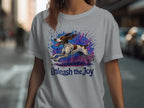 T-shirt with a running dog graphic and the text "Unleash the Joy."