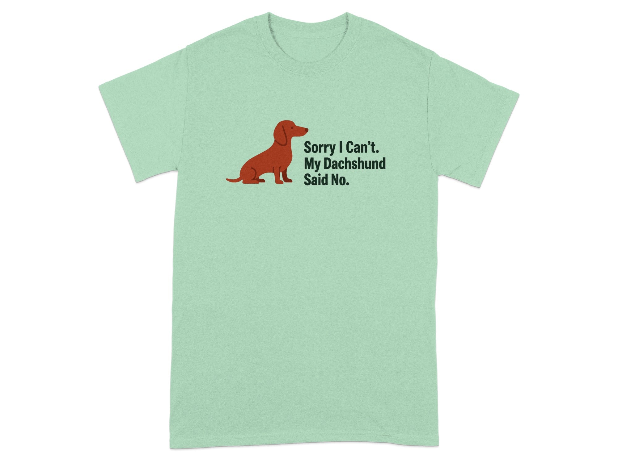 Light green t-shirt with a brown dachshund illustration and text reading "Sorry I Can't. My Dachshund Said No."