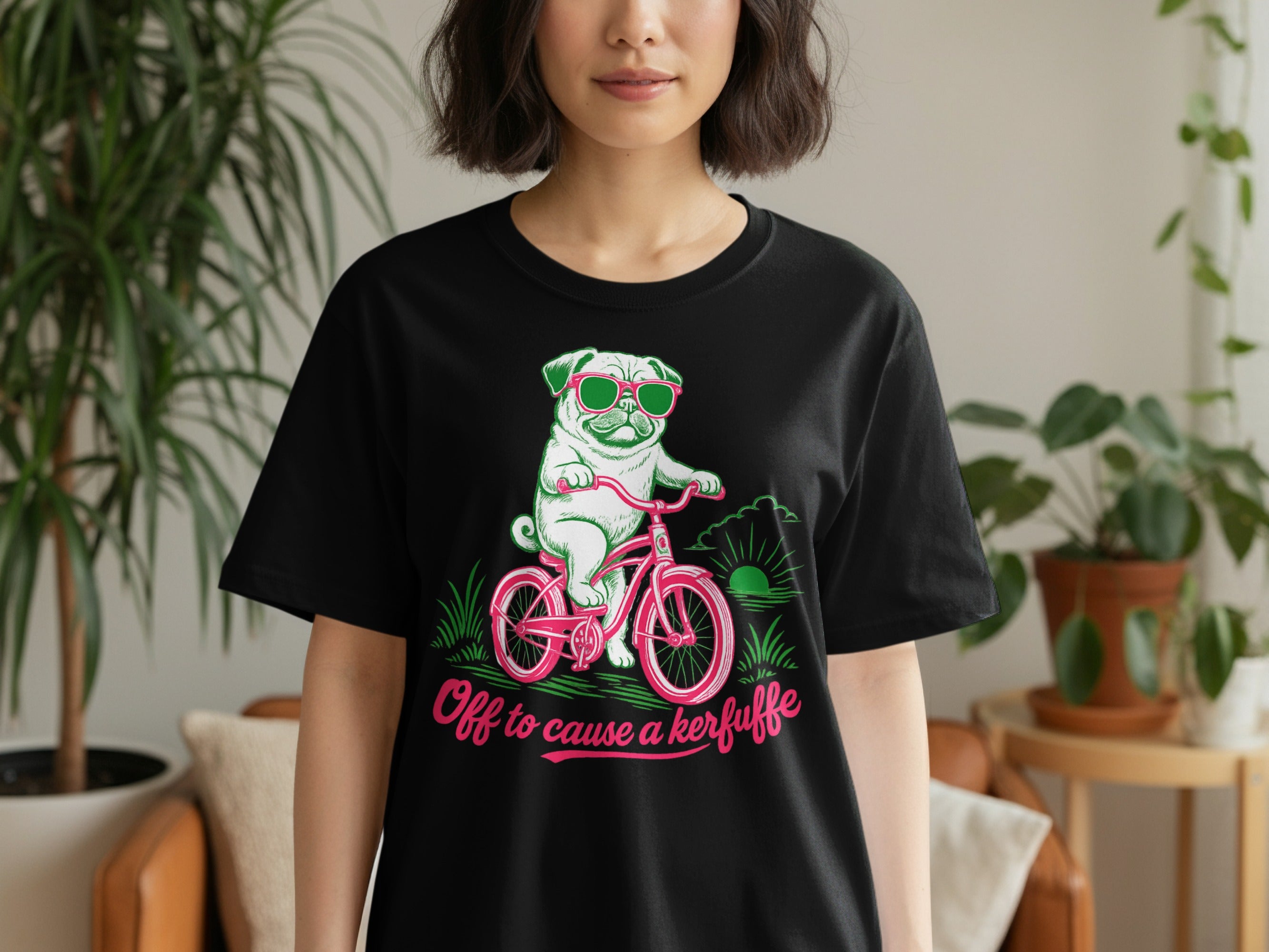 Black t-shirt with a pug wearing sunglasses riding a pink bicycle with text.