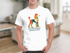 White t-shirt with a geometric poodle illustration and text that reads "feral little creature, perfectly formed".
