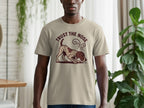 Light tan t-shirt with graphic of a dog smelling the ground and text "TRUST THE NOSE".