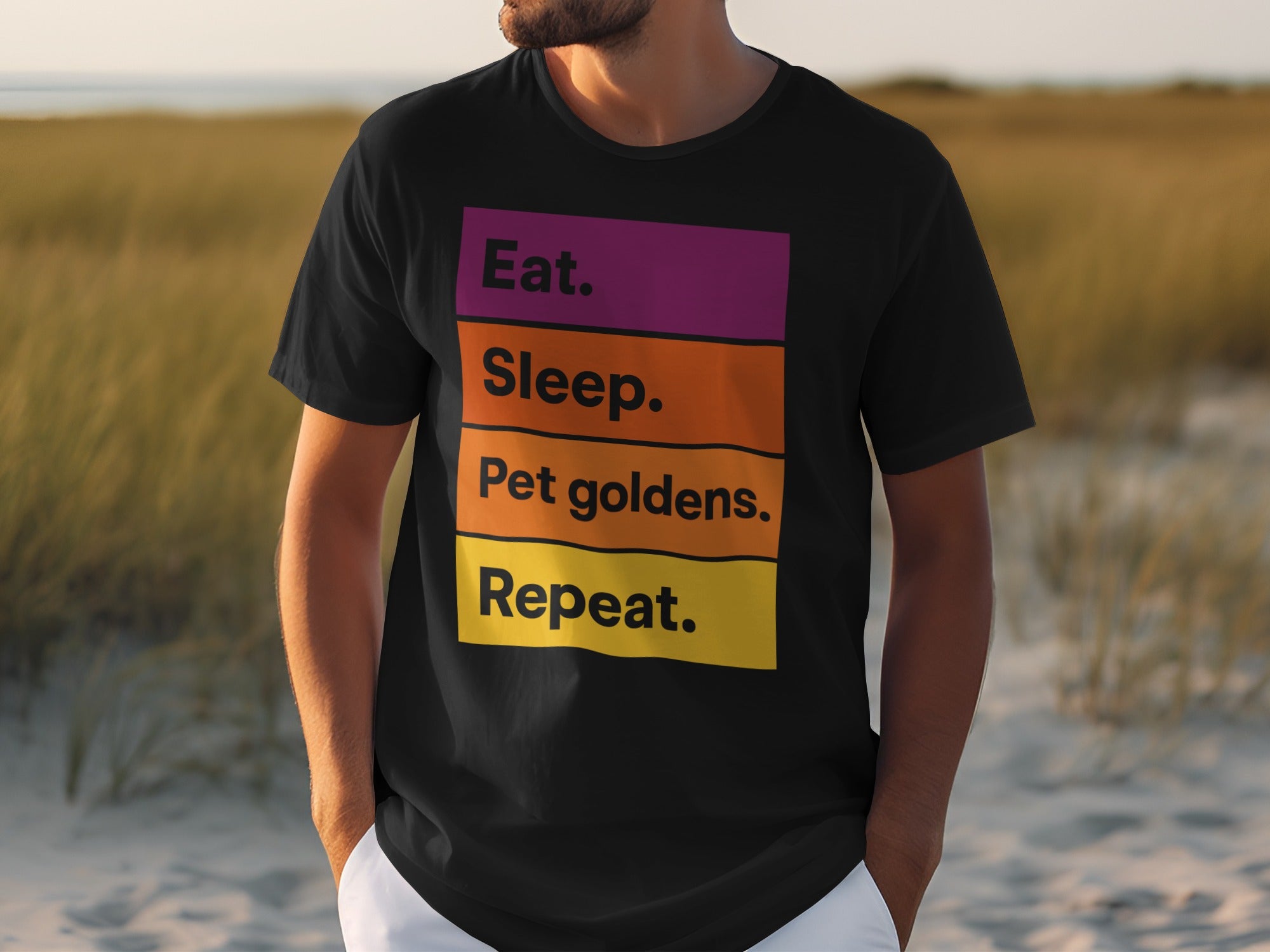 Black t-shirt with "Eat. Sleep. Pet goldens. Repeat." text in colorful blocks.