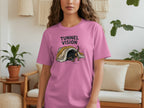 Pink t-shirt with a graphic of a dachshund peeking out from under a blanket.