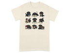 Nine illustrated black puppies interact with piles of books on a cream t-shirt.