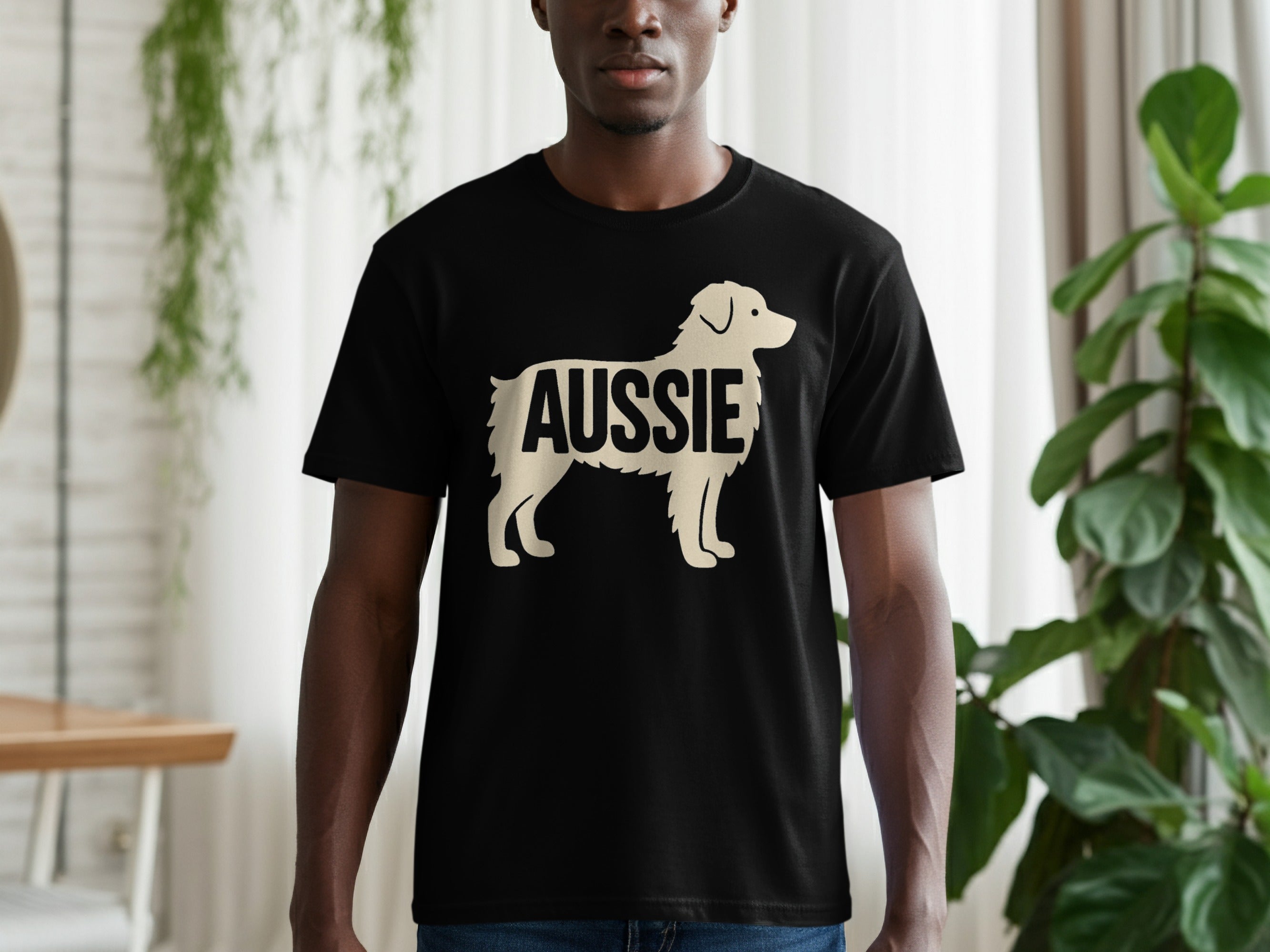 Black t-shirt with a cream silhouette of a dog and the word "AUSSIE".