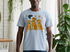 Light blue t-shirt with a graphic of three gold dogs and abstract shapes.