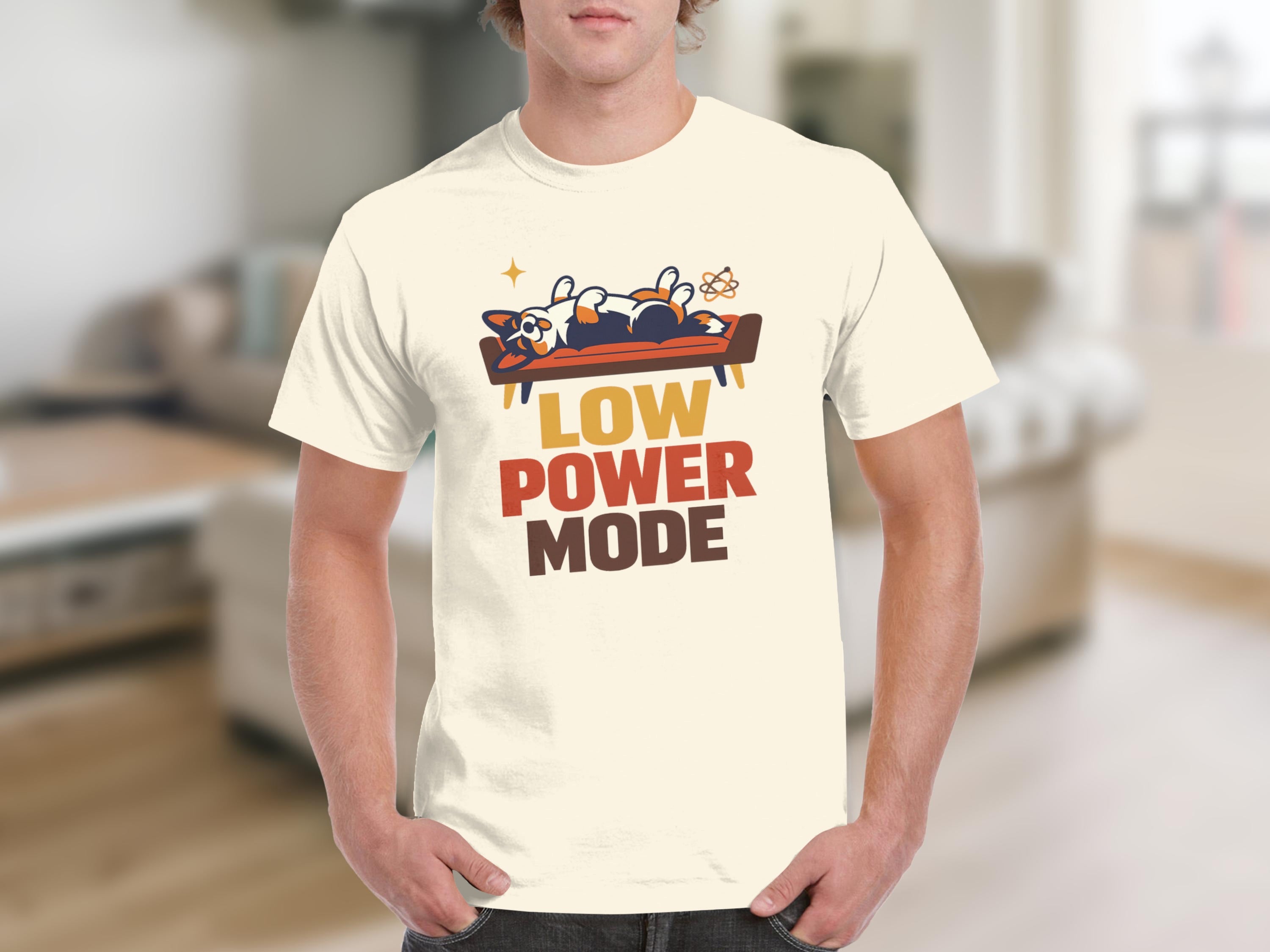 Cream t-shirt with orange, brown, and yellow text and a corgi graphic.