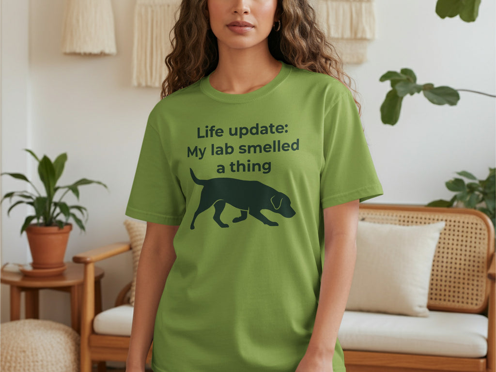 Green t-shirt with a black silhouette of a dog and text.