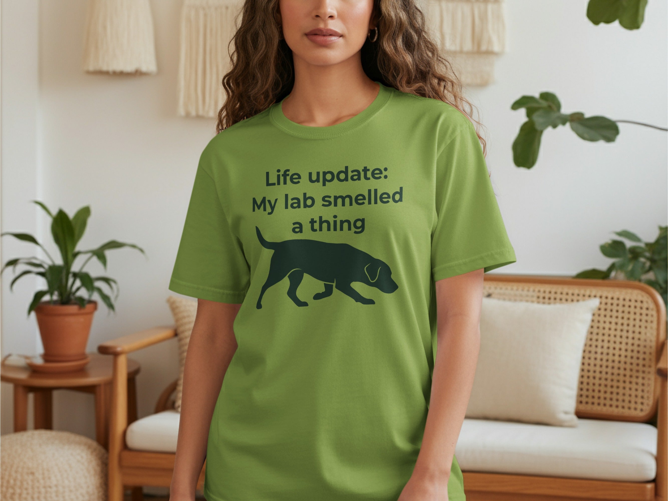 Green t-shirt with a black silhouette of a dog and text.