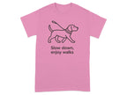 Pink t-shirt with a line drawing of a dog on a leash and text "Slow down, enjoy walks".
