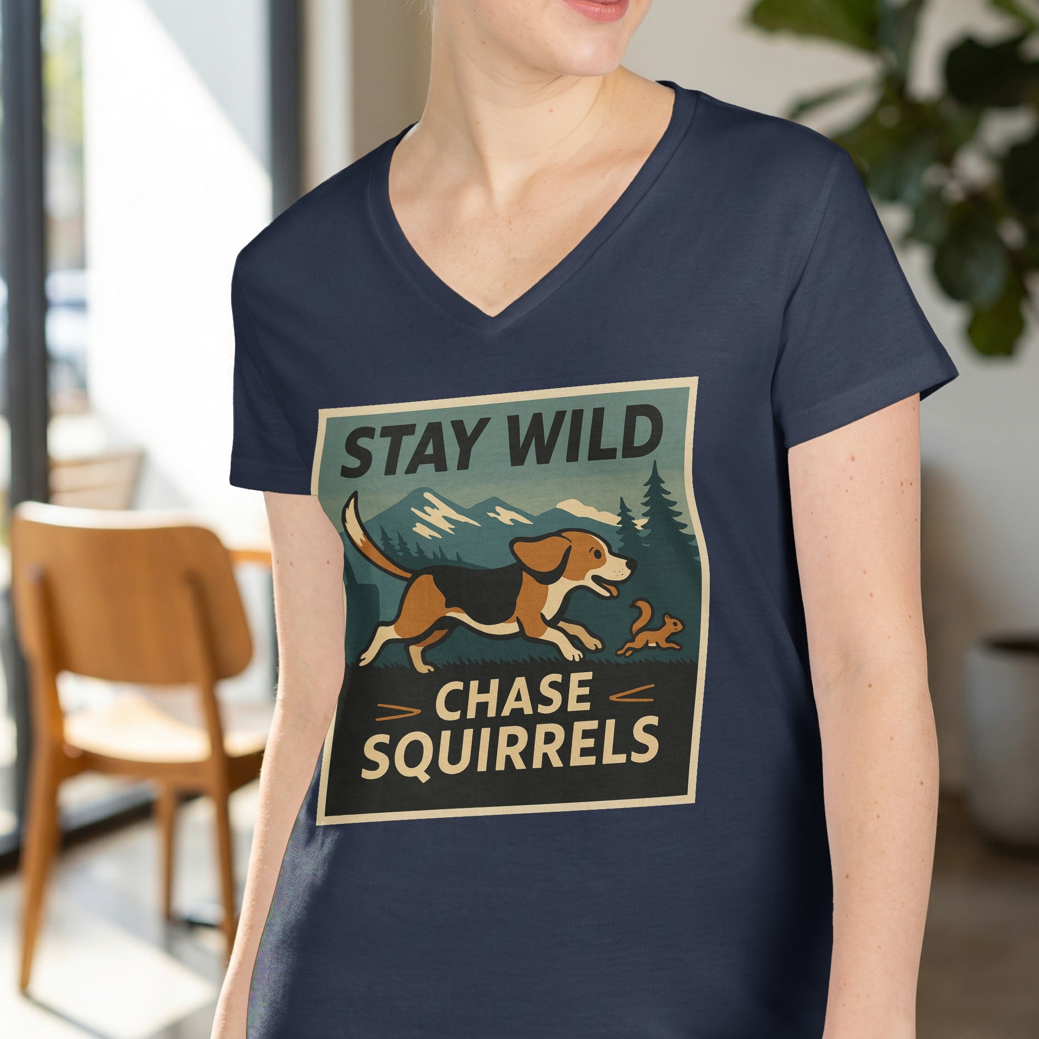 Navy t-shirt graphic with text "STAY WILD CHASE SQUIRRELS" and a beagle chasing a squirrel.