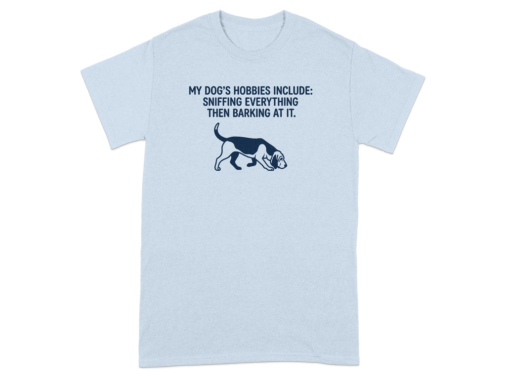 Light blue t-shirt with dog outline and "My dog's hobbies include: sniffing everything then barking at it."