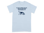 Light blue t-shirt with dog outline and "My dog's hobbies include: sniffing everything then barking at it."