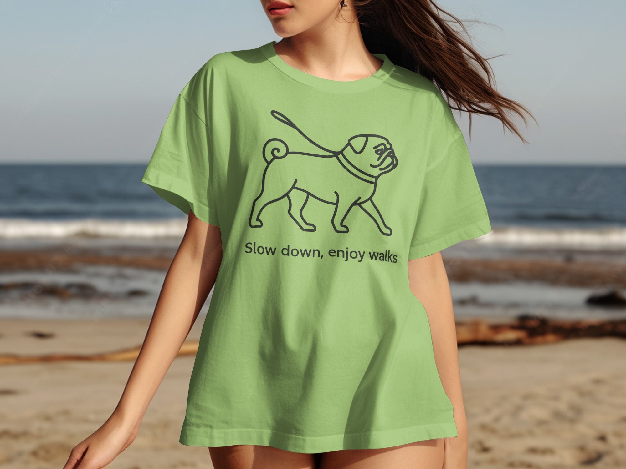 Light green t-shirt with pug graphic and text "Slow down, enjoy walks."