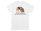 T-shirt with a bloodhound wearing a detective hat and the text "EVERY WALK IS AN INVESTIGATION."