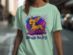 Light green t-shirt with a cartoon chihuahua and "Unleash the Joy" text.