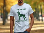 White t-shirt with green Doberman silhouette and text.