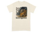 Beige t-shirt with text "Every Walk Is an Investigation" and a dog in a deerstalker hat.