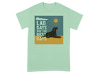 Mint green t-shirt with graphic: black dog, sun, clouds, text "LAB DAYS ARE THE BEST DAYS".